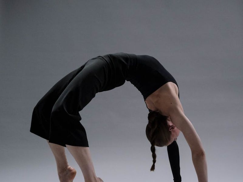 Detailed view of a person performing a controlled yoga stretch.