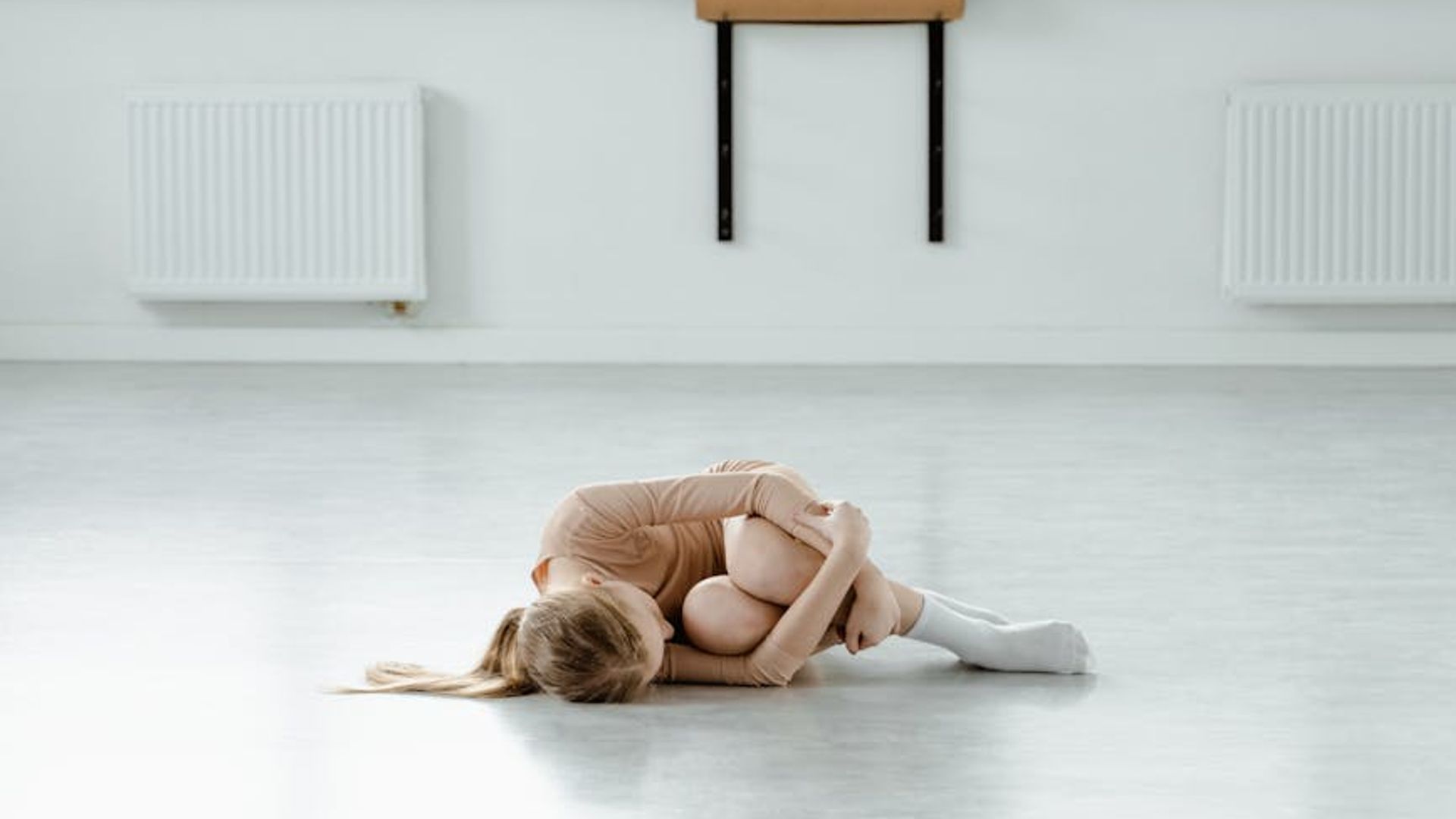 Serene yoga studio with soft green lighting and minimalist design.